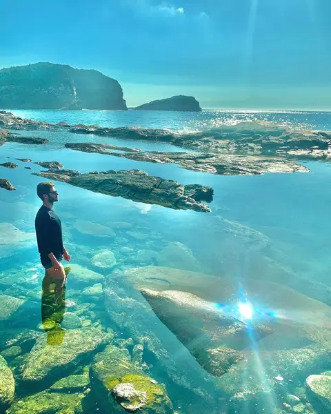 Active tourists looking out over the turquoise ocean during a private outdoor buggy tour at an iconic viewpoint in Búzios.